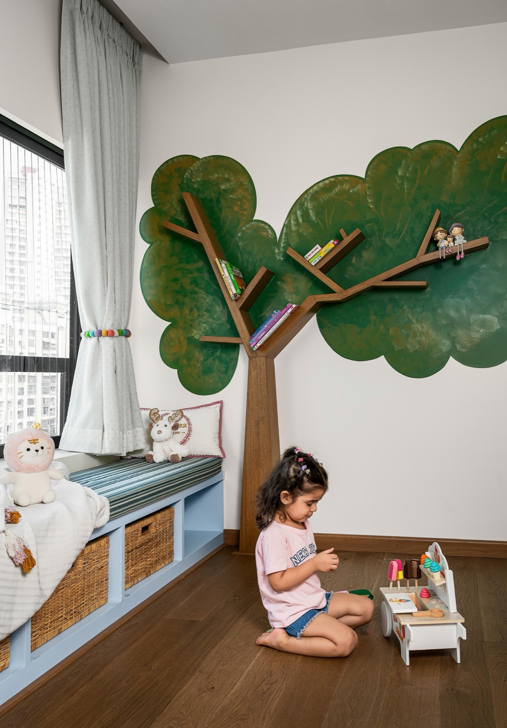 Children's room with hand-crafted tree bookshelf and window seat